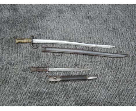 An Italian Sword Bayonet 1891 model with scabbard, blade length 29cm, overall length 39cm and a French Sword Bayonet with sca