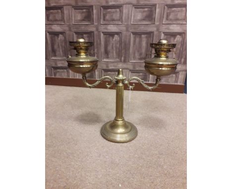 VICTORIAN BRASS DOUBLE OIL LAMP with two scrolling branches issuing from a central fluted column, the reservoirs with moulded