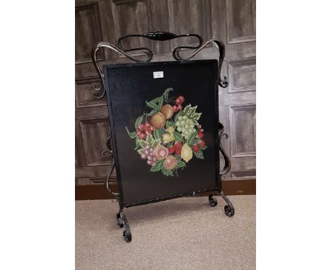 ARTS & CRAFTS WROUGHT METAL AND HAMMERED COPPER FIRESCREEN inset with a later needlework panel of fruit, within within scroll