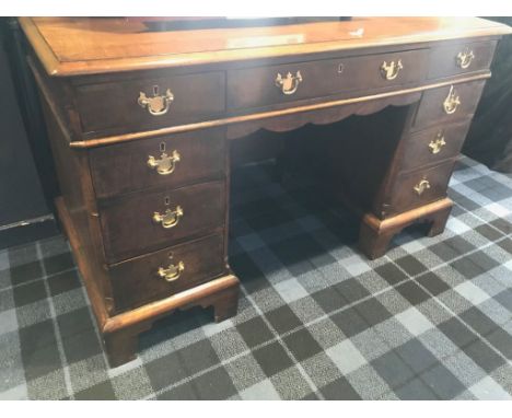 WALNUT CROSSBANDED PEDESTAL WRITING DESK of George I design, the top with moulded edge, three frieze drawers, with three draw