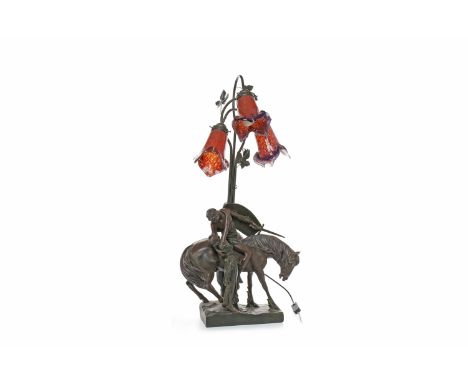 ART DE FRANCE BRONZED SPELTER FIGURAL TABLE LAMPmodelled as a knight leaning down from his steed to a maiden's embrace, the n