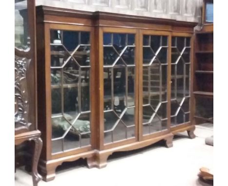 MAHOGANY DWARF BREAKFRONT BOOKCASEof George III design, the moulded cornice with adjustable shelving below, enclosed by four 