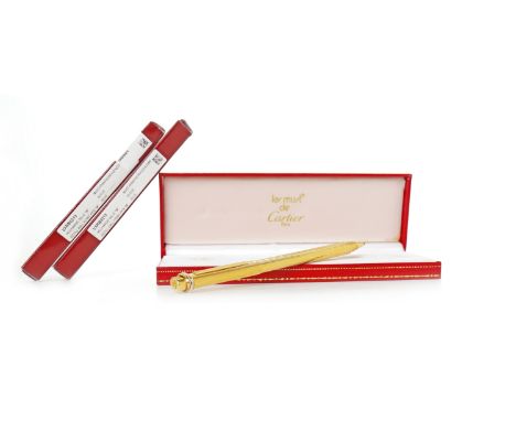 CARTIER 'VENDOME' BALLPOINT PENserial number 102908, engine turned, gold plated body, 13cm long, in original case, with two r