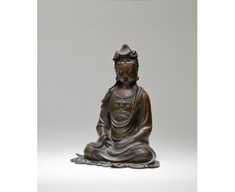 A RARE DOCUMENTARY BRONZE SEATED FIGURE OF GUANYIN17th centuryThe Goddess of Mercy exquisitely cast seated cross-legged, the 