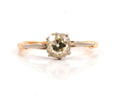 A diamond solitaire ring, the slightly cushion shaped old brilliant cut stone claw set in a traditional mount with yellow met