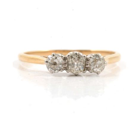 A diamond three stone ring, the old brilliant cut stones claw set in a yellow and white metal traditional three stone mount, 