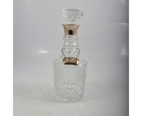 A cut-glass mallet-shape decanter with silver collar, BP Co., London 1984, 29.5cm; and a silver 'Whisky' label.