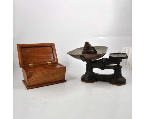 Bleached rosewood two section tea caddy, sarcophagus shape, width 25cm; a set of cast iron scales, with Imperial and Metric w