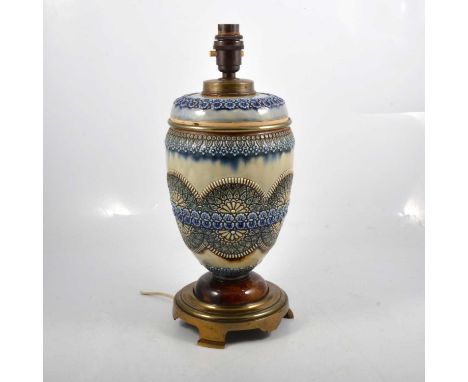 A Doulton Lambeth type stoneware oil lamp, circular brass base, converted to electricity, 35cm.
