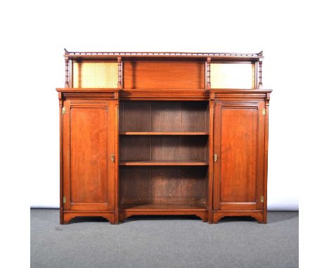 Late Victorian walnut bookcase, raised shelf with spindle gallery, the top with inverted breakfront, central open section wit