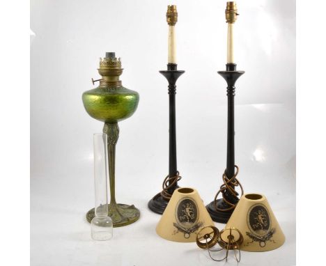 An Art Nouveau style oil lamp with iridescent green reservoir, slender branch and leaf decoration column extending to base, 6