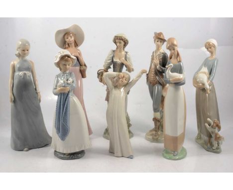 Two Lladro figures, five Nao figures, and another European ceramic figure (Lladro male figre with reglued head).