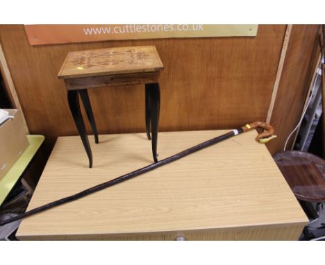 A LARGE WOODEN WALKING STICK WITH HAND PAINTED SNAKE SHAPED HANDLE TOGETHER WITH A MUSICAL JEWELLERY BOX ON LEGS