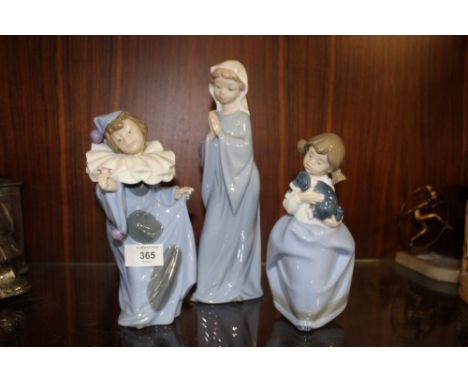 THREE NAO FIGURES, OF A CHILD HOLDING A FLOWER, WOMAN PRAYING, AND A GIRL WITH A DOG