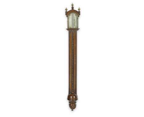 A George III brass mounted mahogany stick barometerthe arched moulded cornice with three onion spine finials, over an opening