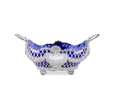 A monumental Edwardian pierced silver two-handled bowl / centrepieceCarrington &amp; Co, London 1909Oval, undulating scroll r