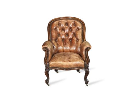 A Victorian walnut low armchair or bergereWith channelled and scrolled foliate carved frames, above a serpentine seat frame, 