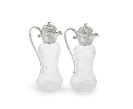 A pair of Art Nouveau silver-mounted cut-glass claret jugsHarrison Brothers &amp; Howson, Sheffield 1899 Of waisted baluster 