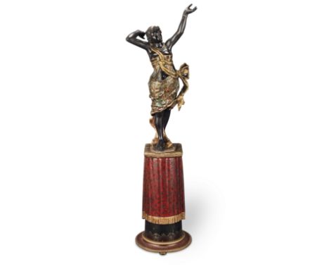 A late 19th century Venetian carved wood and polychrome decorated figure of a Moorish dancer raised on a trompe l'oeil fringe
