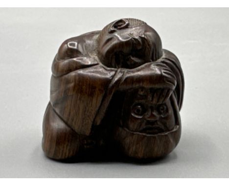 Japanese hand carved Netsuke in the form of a sleeping monk, signed on base, H3cm x W4cm
