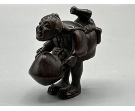 Japanese hand carved Netsuke in the form of a villager, signed on base, H4cm
