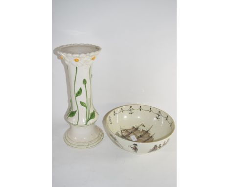 SMALL CERAMIC JARDINIERE STAND DECORATED IN RELIEF WITH FLOWERS TOGETHER WITH A POTTERY MODEL OF HMS VICTORY
