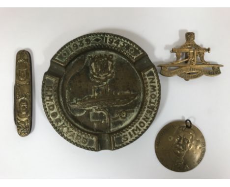 A COLLECTION OF SOUTH AFRICA RELATED ITEMS. A circular brass disk with a portrait of Field Marshall Kitchener, on a small sus