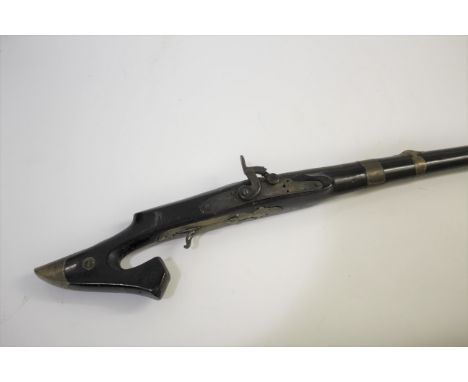 EASTERN PERCUSSION LONG GUN converted from flintlock, with a curved stock and brass butt and with 8 brass barrel bands. With 