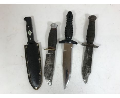 A COLLECTION OF FOUR KNIVES/DAGGERS. Four knives, a late 1960's or 1970's U.S. Airborne survival knife with saw-back blade, 2