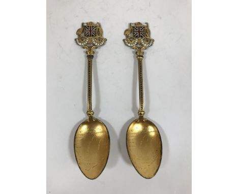 TWO VICTORIAN GILT AND ENAMEL 'SOUTH AFRICA 1900' SPOONS. Two gilt metal spoons with enamelled terminals decorated with a Uni