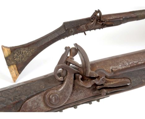 EASTERN FLINTLOCK WALL GUN with an ivory butt with metal strap, flintlock mechanism with French style cock, and with 8 barrel