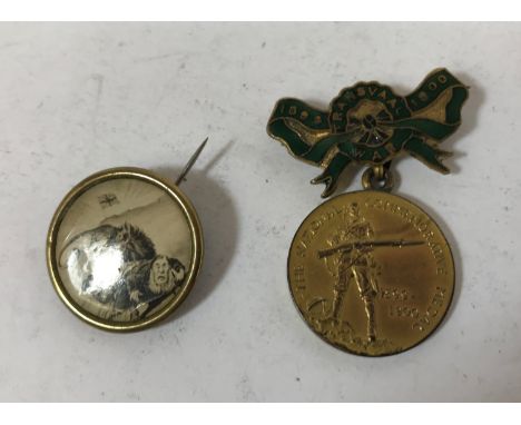 TWO CIVILIAN BOER-WAR BADGES. A Boer-War badge 'The National Commemorative Medal' on a green enamel ribbon suspension, and a 