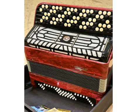 A Russian Tyna 207 Accordion with pearlised red/pink case with leather straps and instructions etc. circa 1970s, bellows appe