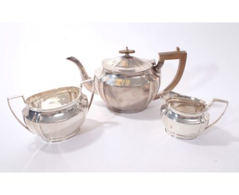 1920s silver three piece tea set, comprising teapot of oval form with fluted corners, angular fruitwood handle and hinged dom