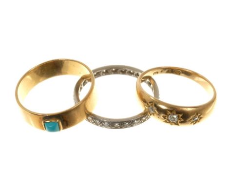 Three rings to include a diamond eternity ring, diamond three stone gypsy ring and a gold band with a turquoise cabochon (3)C