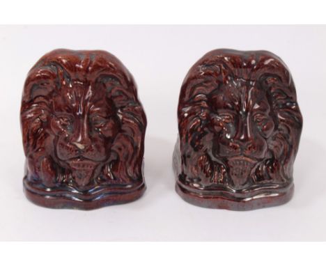 Pair 19th century brown treacle glazed sash window stops moulded with lions masks 12.5cm high