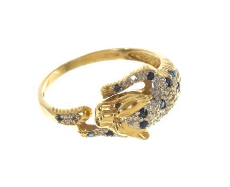 Diamond and blue sapphire dress ring modelled as a leopard with emerald eyes, finger size Q1/2.