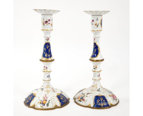 Pair of mid-18th century Bilston enamel candlesticks, knopped form with removable petalled sconces and blue and gilt reserves