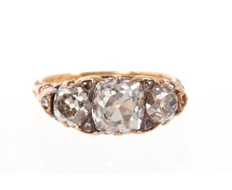 Victorian diamond three stone ring with a central cushion-shape old cut diamond measuring approximately 6.7 x 6.9 x 5.2 mm fl