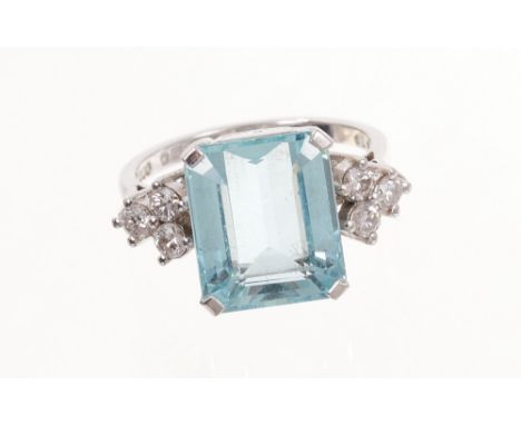 Aquamarine and diamond ring with a rectangular step cut aquamarine measuring approximately 12.35mm x 10.30mmx 6.20mm flanked 