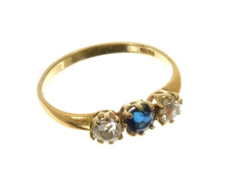 Diamond and sapphire three stone ring with a round mixed cut blue sapphire flanked by two old cut diamonds in gold claw setti