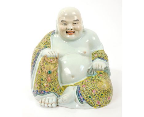 Late 19th century Chinese famille rose figure of Butal, the corpulent monk, seated with polychrome painted robes decorated wi