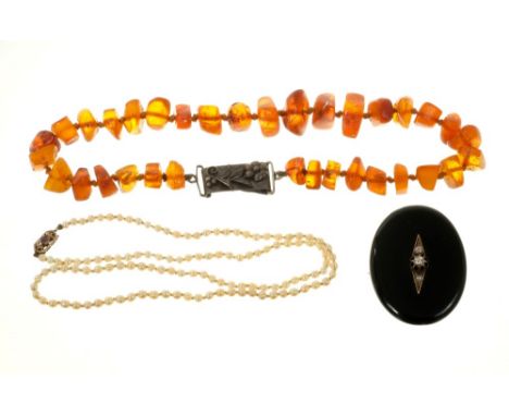 Antique cultured pearl necklace, Victorian black enamel locket/brooch applied with rose cut diamonds and an amber necklace.