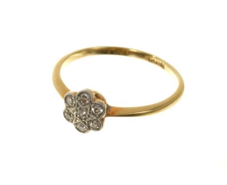 1930s diamond dress ring with a flower head cluster of single cut diamonds mille grain setting on 18ct gold shank. Finger siz