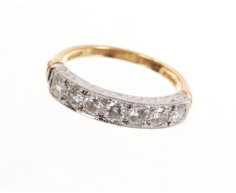 Diamond and gold eternity ring, the half hoop with a band of seven brilliant cut diamonds in mille grain setting on 18ct yell