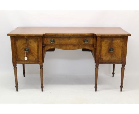 George III mahogany crossbanded inverted breakfront sideboard, with single frieze drawer, flanked by pair of deep drawers on 