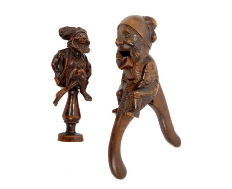 Novelty 19th century Black Forest figural nut cracker, carved as a jovial fellow seated on a column, 16cm high, together with