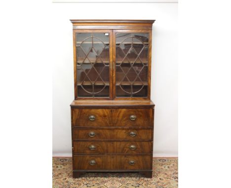 George III mahogany two height secretaire bookcase, the upper shelved section with geometric inlaid cornice and enclosed by p