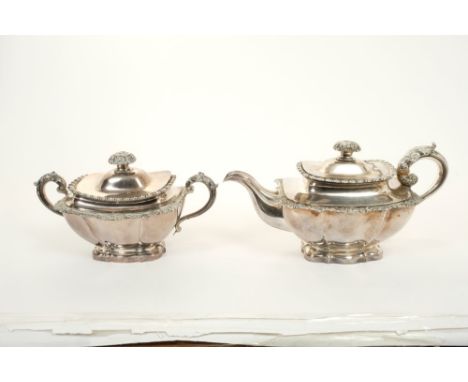 Early 19th century French silver teapot of fluted form, with gadrooned and floral borders, leaf mounted handle with ivory ins