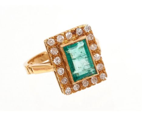 18ct gold emerald and diamond cluster ring with a rectangular step cut emerald measuring approximately 9.1mm x 6.0mm x 3.9mm 